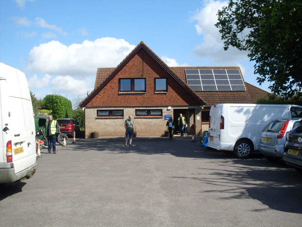 The village  hall  under a blue sky.
