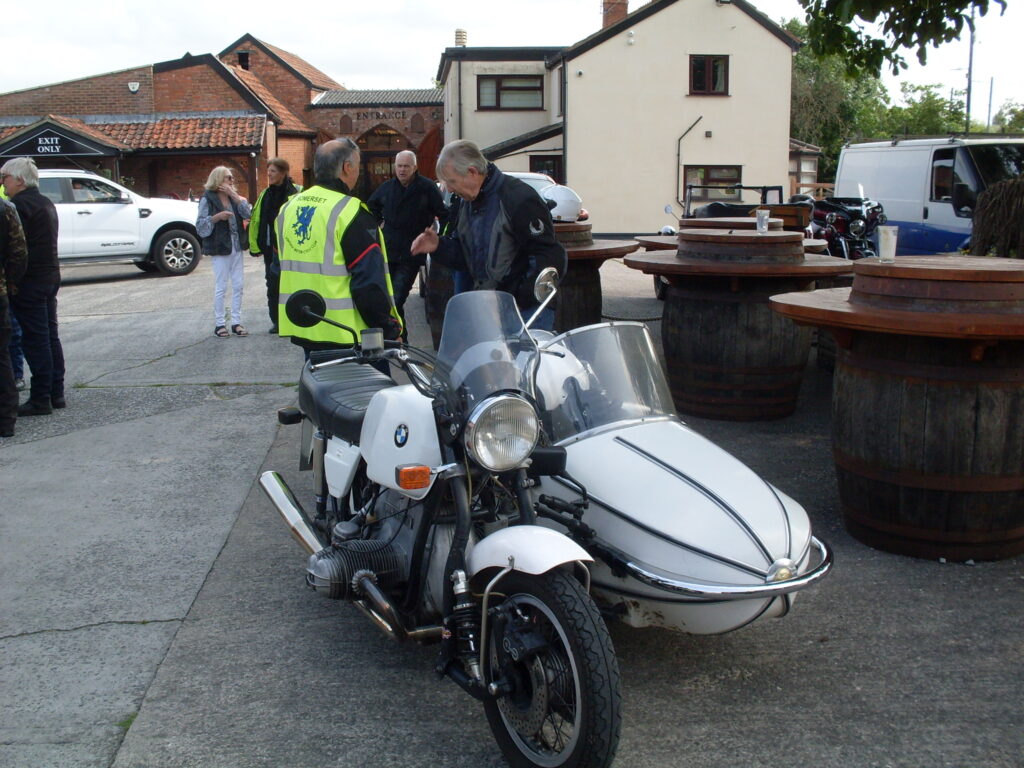 White air-cooled BMW twin and sidecar, the motorbike equiped with special leading-link front forks.