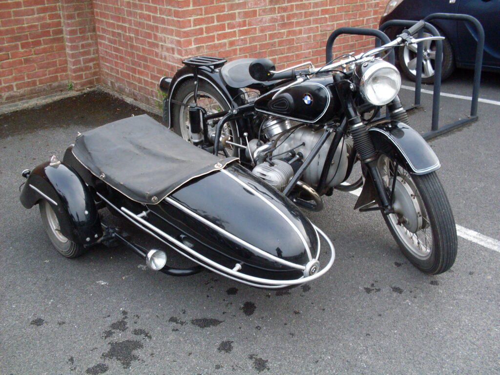 A view of one vehicle, the black 'boxer BMW' outfit with its low single-seat sidecar.