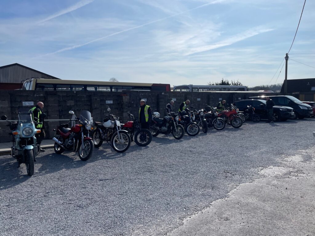 Looking down the line of parked motorcycles  from the other end.