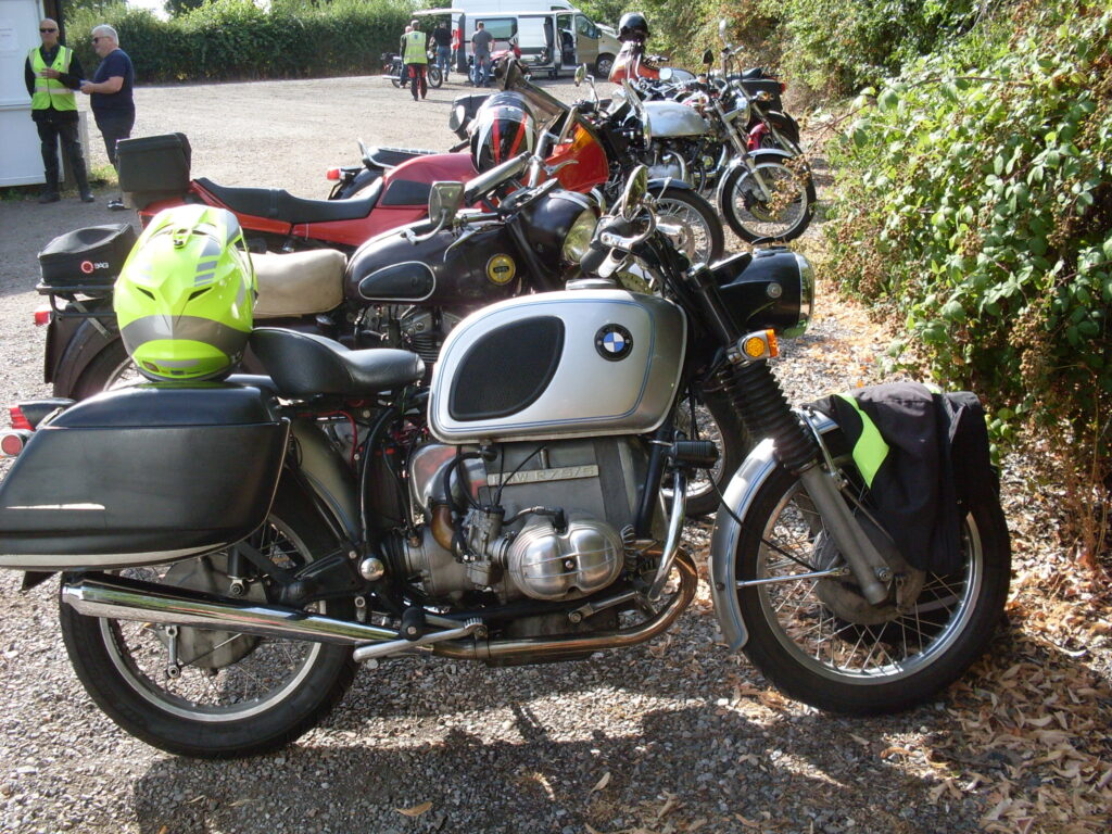 A 1970s BMW 'boxer' twin with a pair of non-standard pannies with round-edged fronts and back faces that slope to a 'streamlined' point at the  back' 